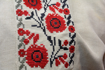 Fragment of an ancient authentic embroidery on a man's shirt.