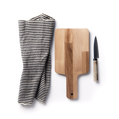 Wooden chopping board and knife with a striped cloth