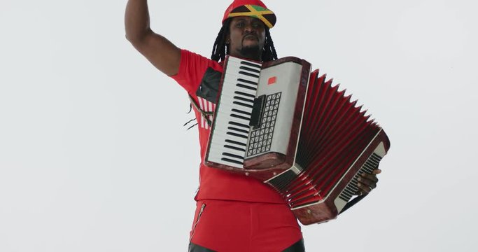 Close-up African musician playing accordion in slow-motion.