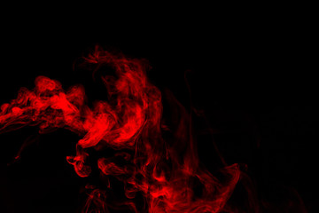 Red smoke isolated on black background.