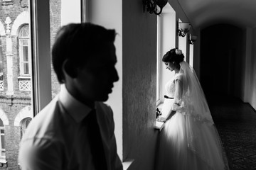 Black and white photo of groom and bride inside the old building