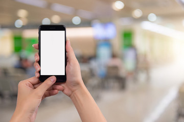 Young woman holding smart phone with blurred background. For Graphic display