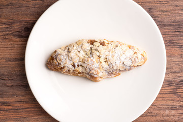 Almond croissant  filled with almond cream and topped with sliced almonds