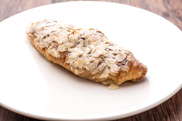 Almond croissant  filled with almond cream and topped with sliced almonds