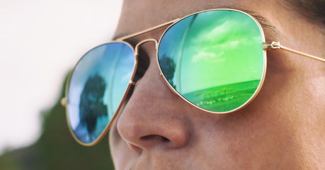 Girl with pilot sunglasses on the beach with reflection, panorama photo