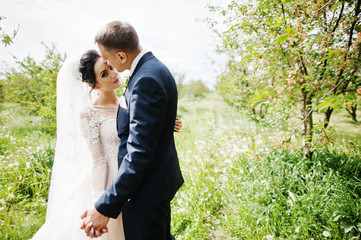 Fabulous wedding couple having their time outdoors in the garden on a special day.