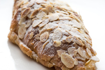 Almond croissant  filled with almond cream and topped with sliced almonds