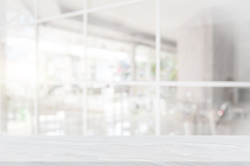 White marble table top on blur coffee shop