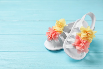 Pair of cute baby sandals on wooden background