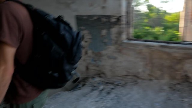 Ranger walks in ruins of abandoned post apocalyptic building