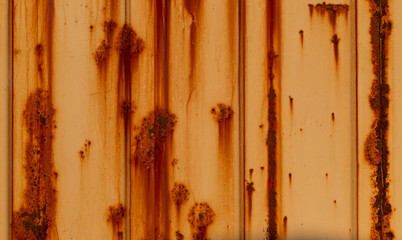 Close up detail of old weathered rusty orange shipping container 