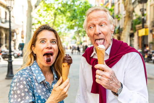 Senior couple eating ice cream and having fun in Barcelona