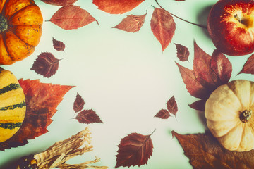 Autumn background with colorful pumpkins and fall leaves, top view, frame