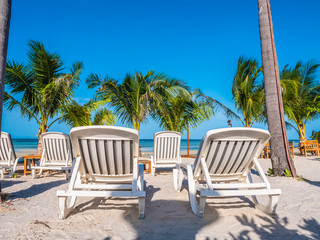 Obraz na płótnie Canvas Umbrella and chair on the beach and sea ocean with blue sky