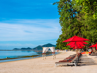 Umbrella and chair on the tropical beach sea and ocean
