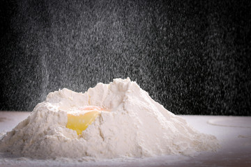 Making dough by female hands at home in kitchen