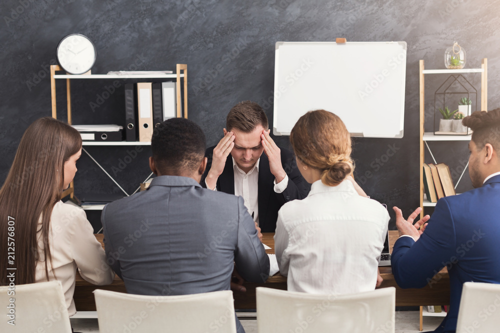 Wall mural stressed applicant at job interview with headache