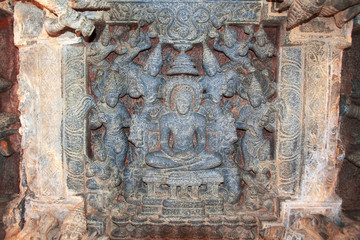Carved figure of Jain tirthankara with his consorts at the ceiling of large common open hall called the mahamantapa or navaranga, Panchakuta Basadi, Kambadahalli, Mandya district, Karnataka