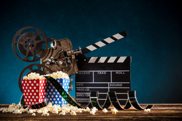 Cinema concept of vintage film reel with popcorn.