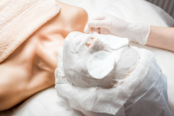 Woman having peeling in spa salon. Procedure, mask