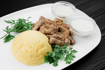 Mamaliaga or polenta with cheese and beef meat. Traditional food of Moldovan and Romanian.