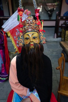 Fototapeta Miao person wearing traditional mask