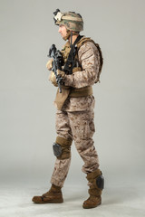 Soldier in camouflage holding rifle