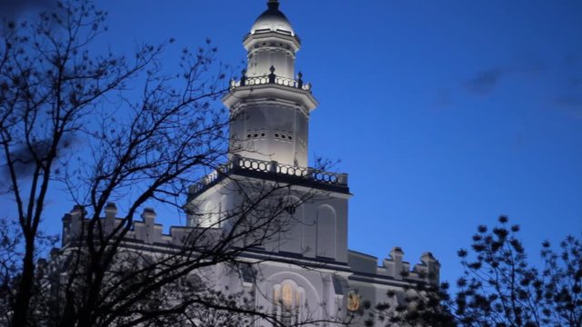 The St. George Utah Mormon Temple, A tall white building lit up at night.