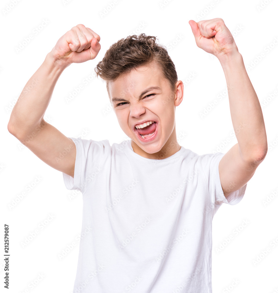 Sticker Emotional portrait of caucasian teen boy. Victory screaming teenager wearing white t-shirt, isolated on white background. Funny winner child shouting with his hands up.