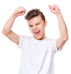 Emotional portrait of caucasian teen boy. Victory screaming teenager wearing white t-shirt,...