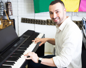 man buying synthesizer