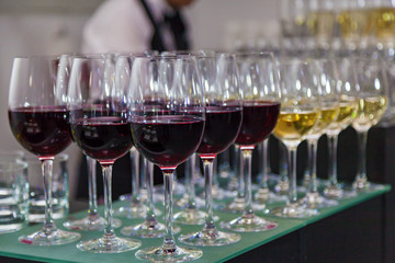 glasses with red wine on the bar