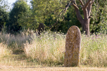 Picturesque English countryside graveyard. Ancient rural churchyard cemetery burial site.