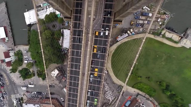 Aerial drone shot of traffic crossing the Brooklyn Bridge in New York City.