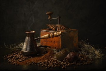 coffee ground and in grains. Old coffee grinder and cezve..