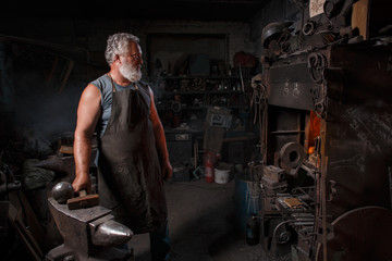 Blacksmith with brush handles the molten metal