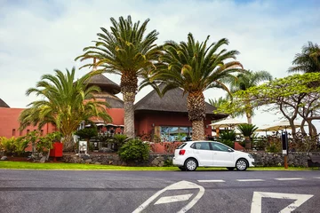 Poster small cozy street with parked cars near Abama beach on Tenerife, Canary islands, Spain © bondvit