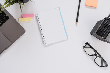 Top view of modern workspace office desk table with note page blank