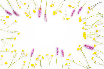 Lilac and yellow flowers on white background, flat lay, top view