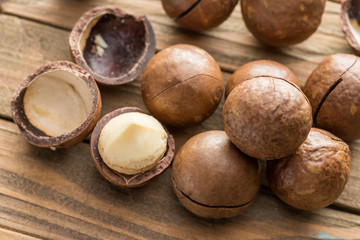 Macadamia nuts or bush nuts on the wooden table.
