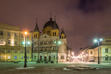 Fototapeta na wymiar Church at Piotrkowska street at night in Lodz city, Lodzkie, Poland