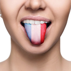 Young woman showing tongue with france flag.