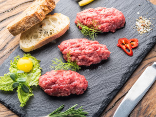 Steak tartare served with capers, pickled cucumbers and chopped onion.