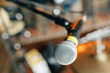 microphone on a stand on a background of musical instruments