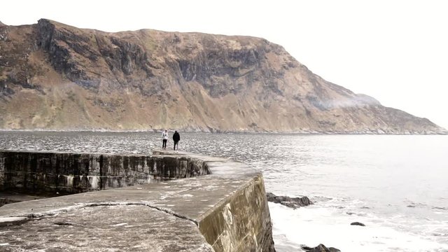 People walking on breakwater