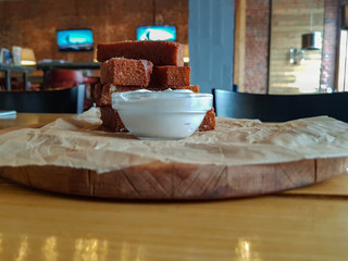 Slices of rye bread fried in oil with salt, garlic and sour cream sauce
