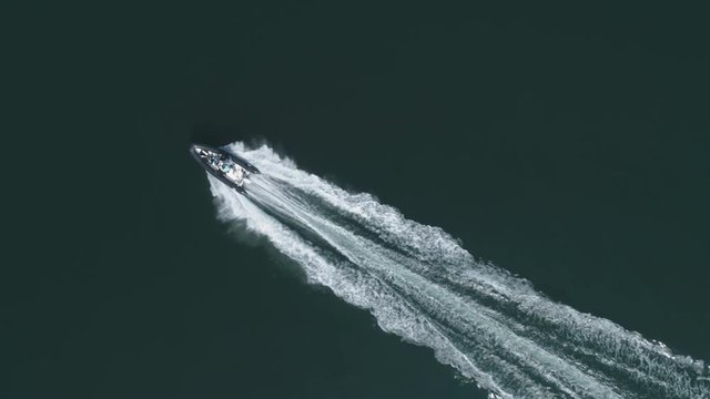 A dinghy moving on the Baltic Sea and filmed by a drone