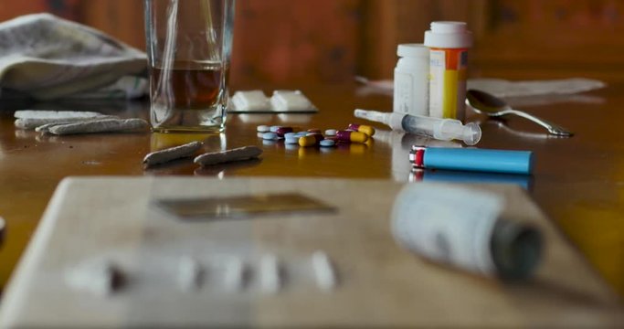 Assortment of illegal drugs representing abuse and addiction - rack focus