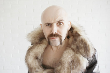 brutal mustachioed man in a fur coat