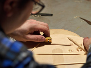 The process of making a classical guitar. Making the right shape of a brace guitar.